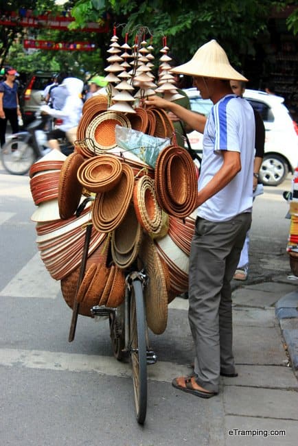 A bicycle packed with different kinds of traditional hats for sale.
