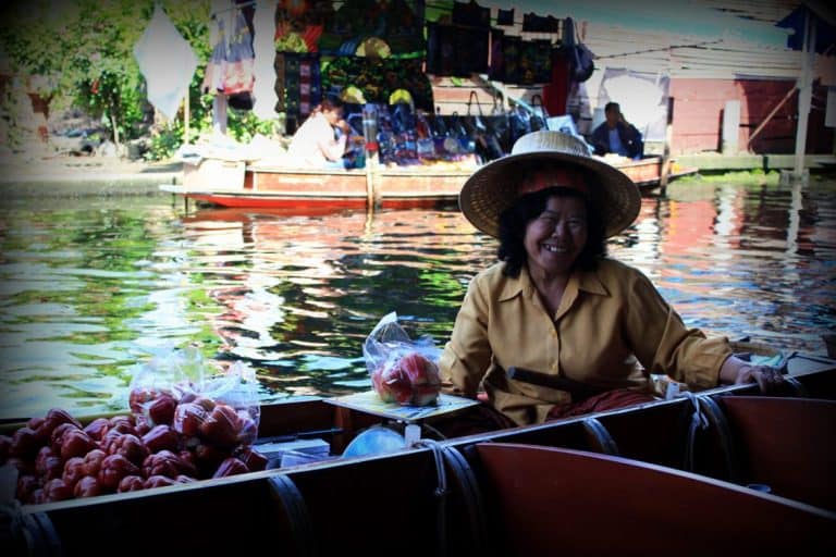 Thai woman smiling, Floating Market in Thailand