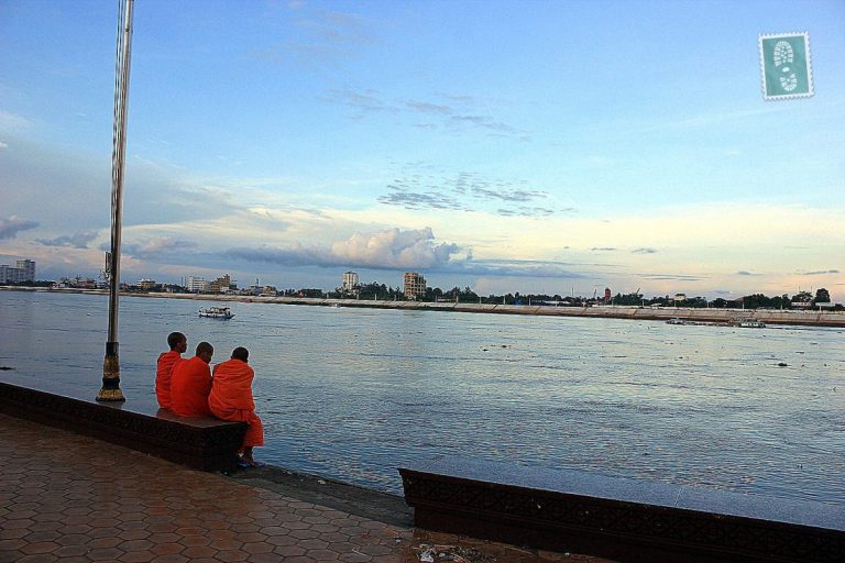 3 Cambodian monks sitting at the river