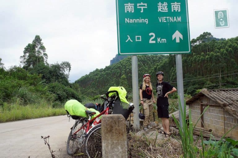 Naning border two people are standing with bikes