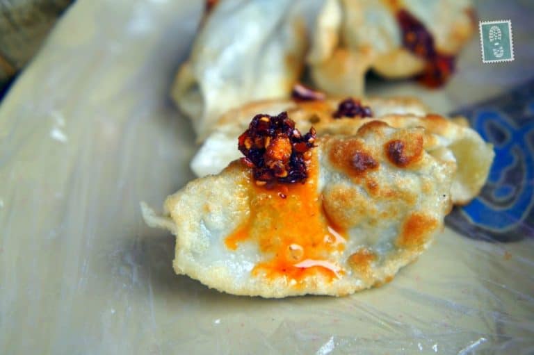 Fried Jiaozi with some spicy chili oil sauce, yummy!