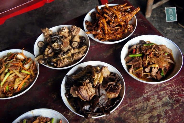 Chinese New Year's food - spicy chicken's legs, mushrooms, all edible parts of pig and chicken with fried veggies