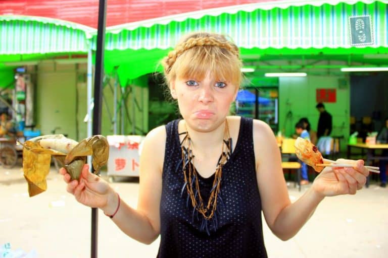 A girl is holding a sticky rice leaf and jiaozi in china