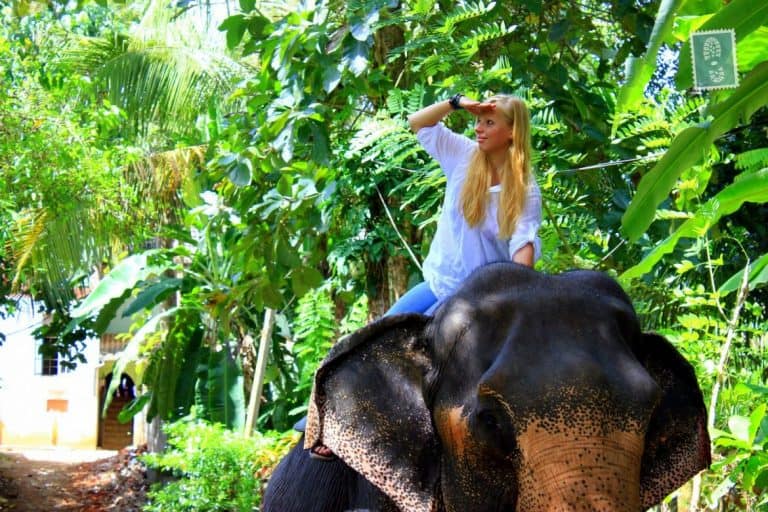 A girl is riding an elephant