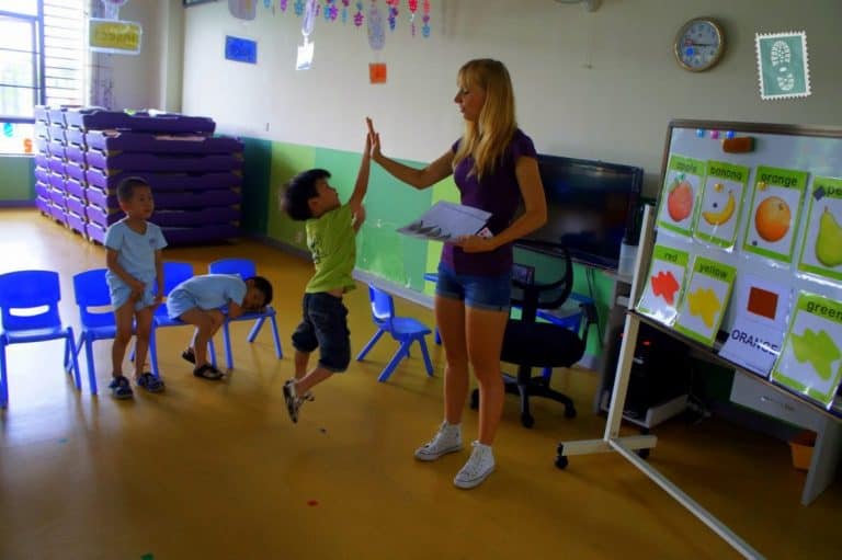 A foreign teacher and high five with Chinese students