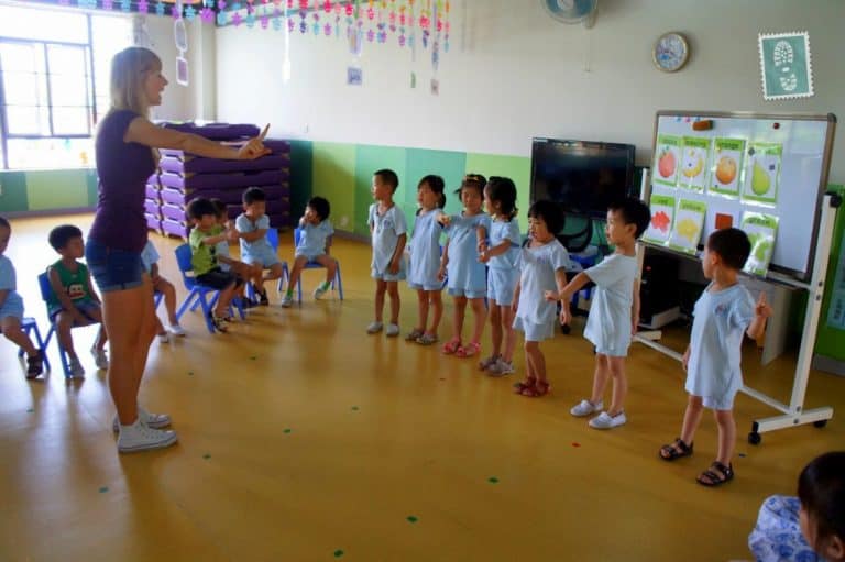 A foreign teaching is teaching students a new song