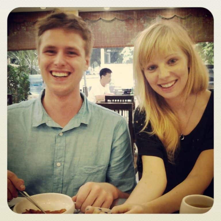 A couple eating a Korean food and smiling