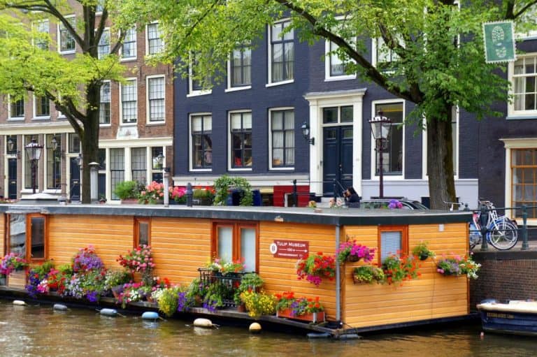 Tourist boats ply their trade on the numerous canals that criss-cross the historical centre of Amsterdam