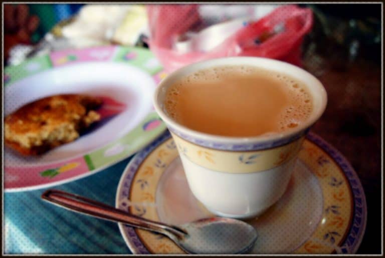 Sri Lankan breakfast A cup of sweet milky tea and a piece of cake