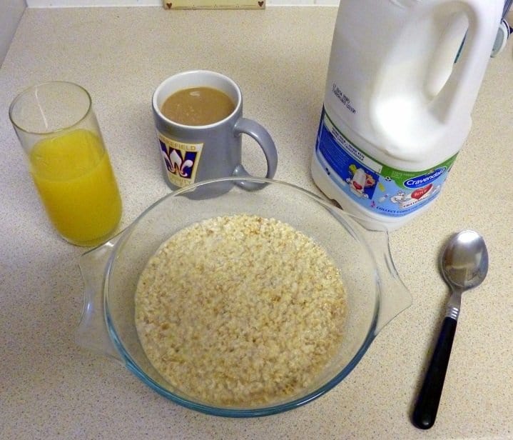 International breakfast A bowl of porridge with milk, a glass of orange juice and a cup of coffee