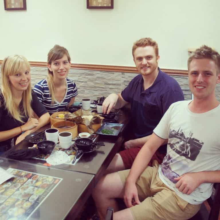 four people are eating dim sum in Hong Kong