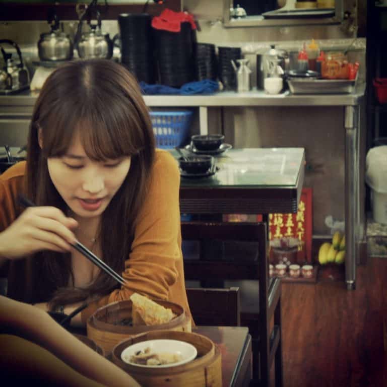 A girl is eating dim sum in Hong Kong Dim Sum Square Restaurant