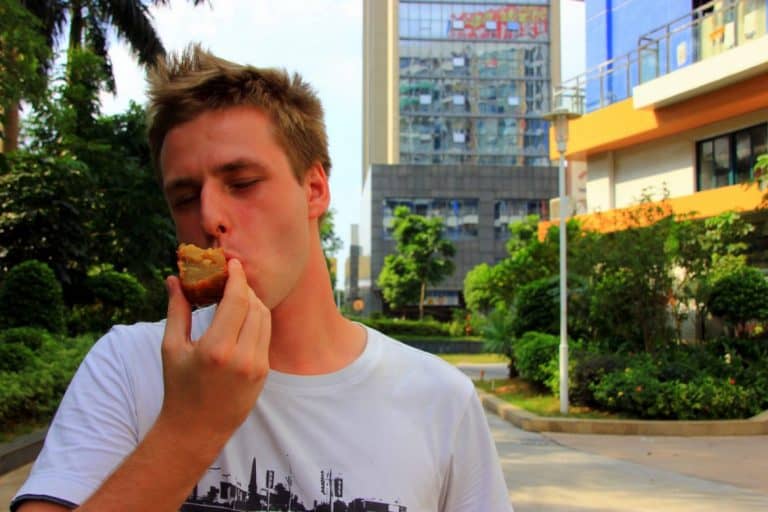 A boy is eating a mooncake