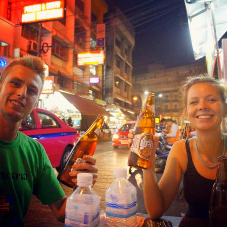 Two people are drinking a Thai beer