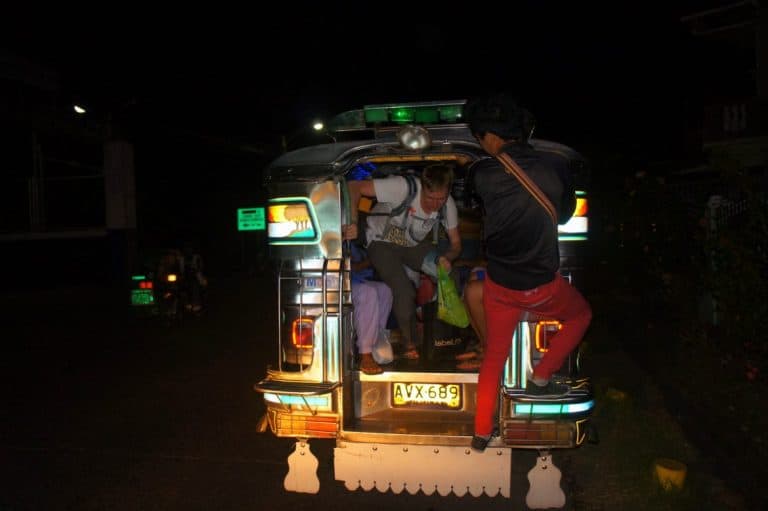 A boy trying to get out of jeepney in Manila