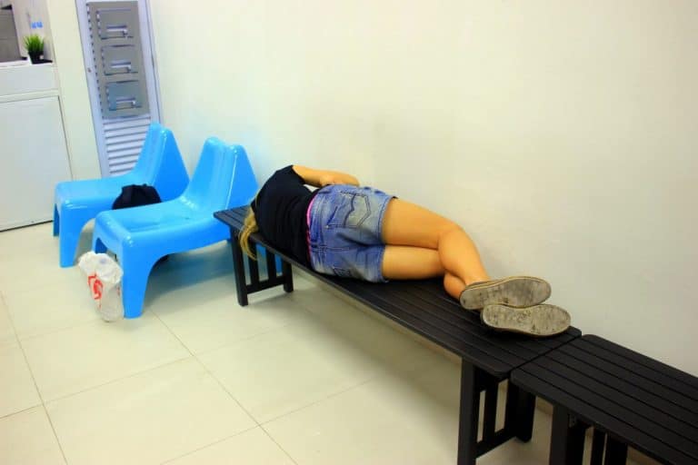A girl having a nap in a laundry room