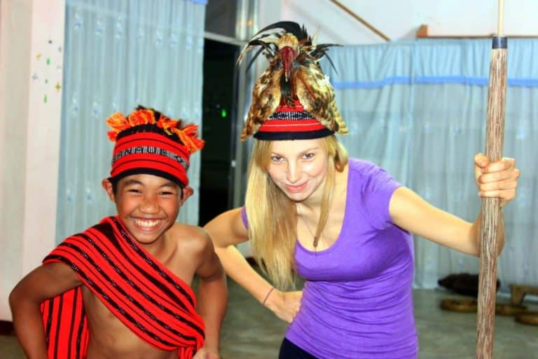 Agness is posing with a boy in Banaue