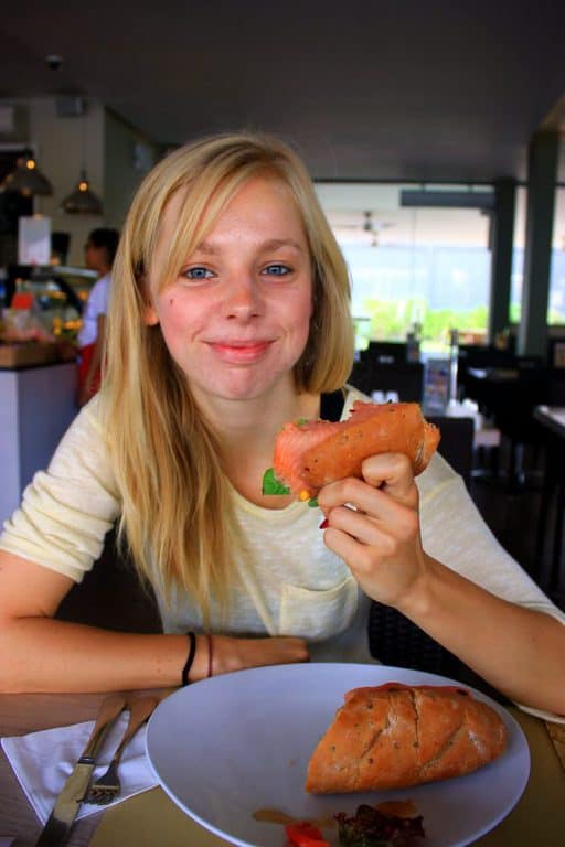 A girl is eating a sandwich