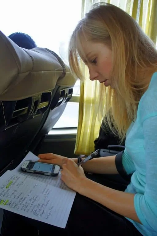 Making notes on the bus to Hong Kong