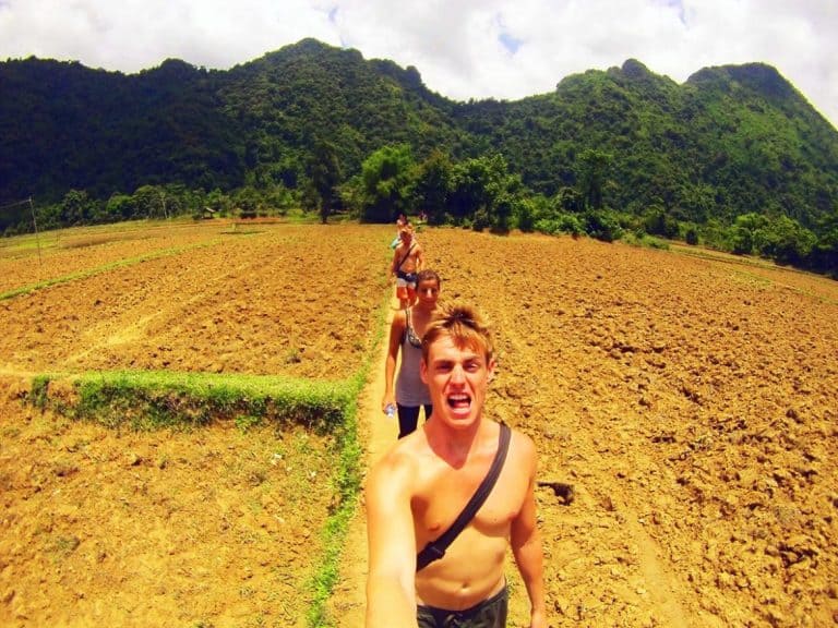 Walking-through-Rice-Paddies,-Vang-Vieng