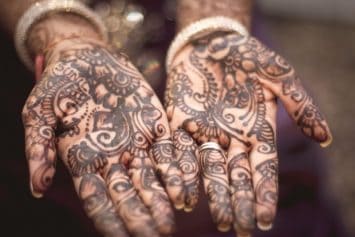 Woman's hands covered with henna patterns