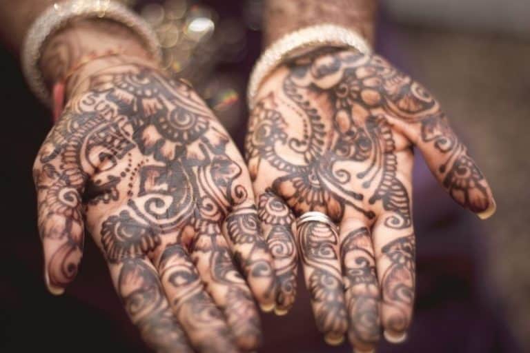 Woman's hands covered with henna patterns