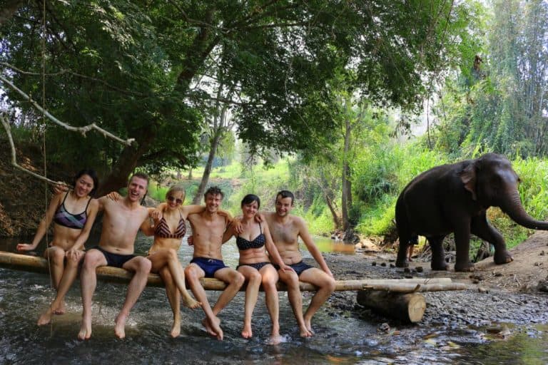 Group picture at the river with elephants in Chiang Mai