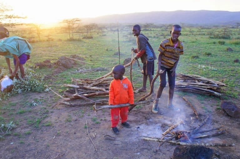 Maasai kids preparing the bonfire. 
