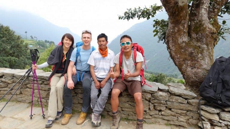 Four friends on a wall on the Everest Base Camp Trek