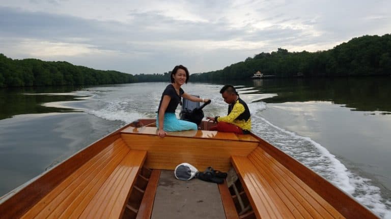 Lydia pilots a boat through Brunei mangroves