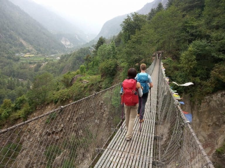 Lydia and Cez cross a chain bridge on the Everest Base Camp trek