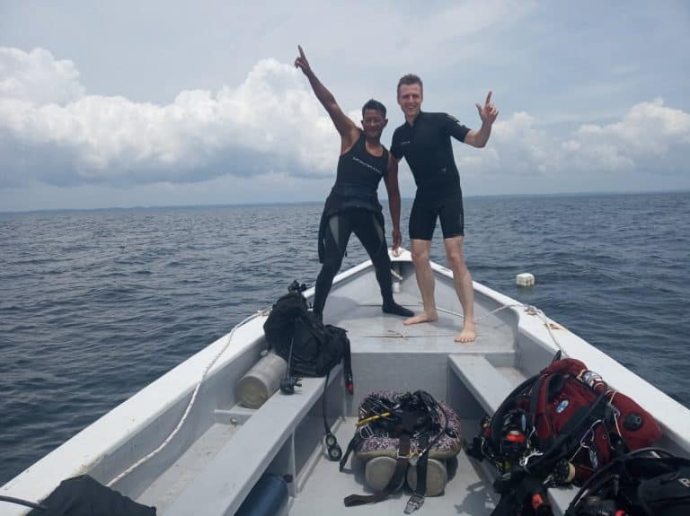 Two guys on a boat making funny poses