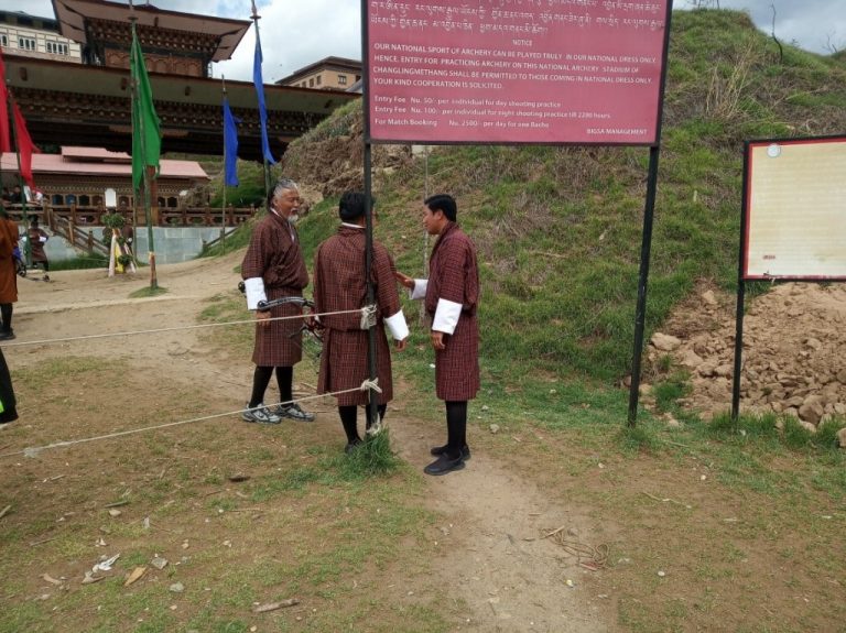 Three Bhutanese men in conversation