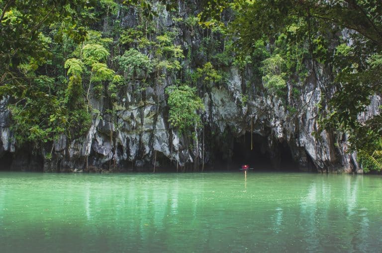 Entering the caves on a paddle boat through the river.