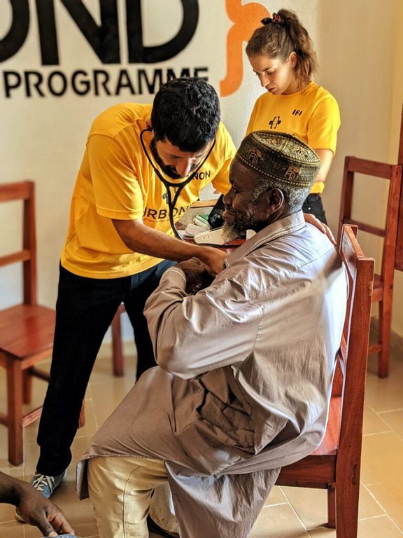 doctor examining patient in guinea
