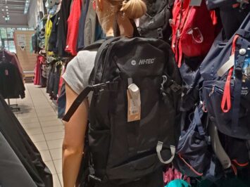 black backpack carrying woman in store