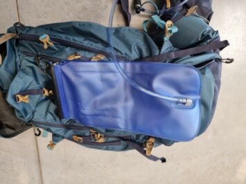 blue hydration bladder attached to backpack