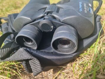 close up of binoculars on grass