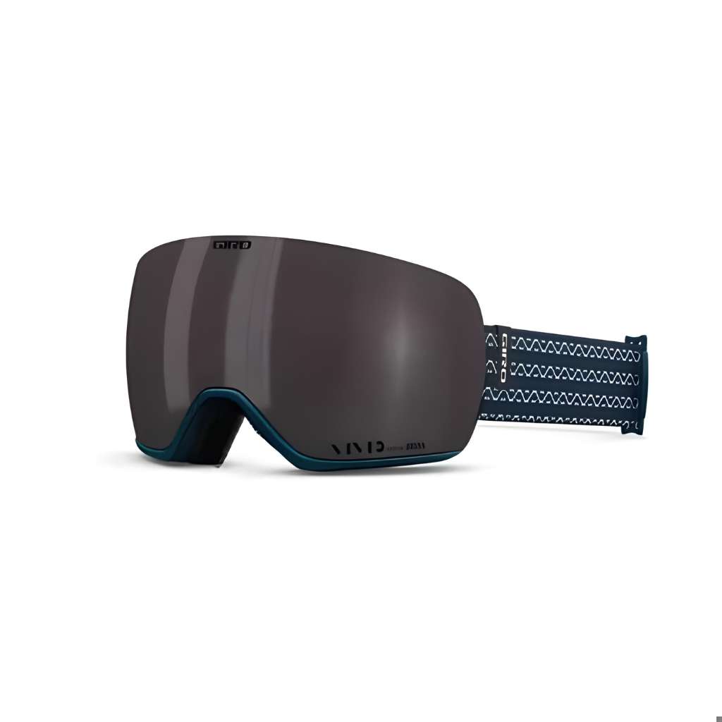 Giro Article II snow goggles featuring a large dark-tinted cylindrical lens, teal frame accents, and a patterned blue strap.